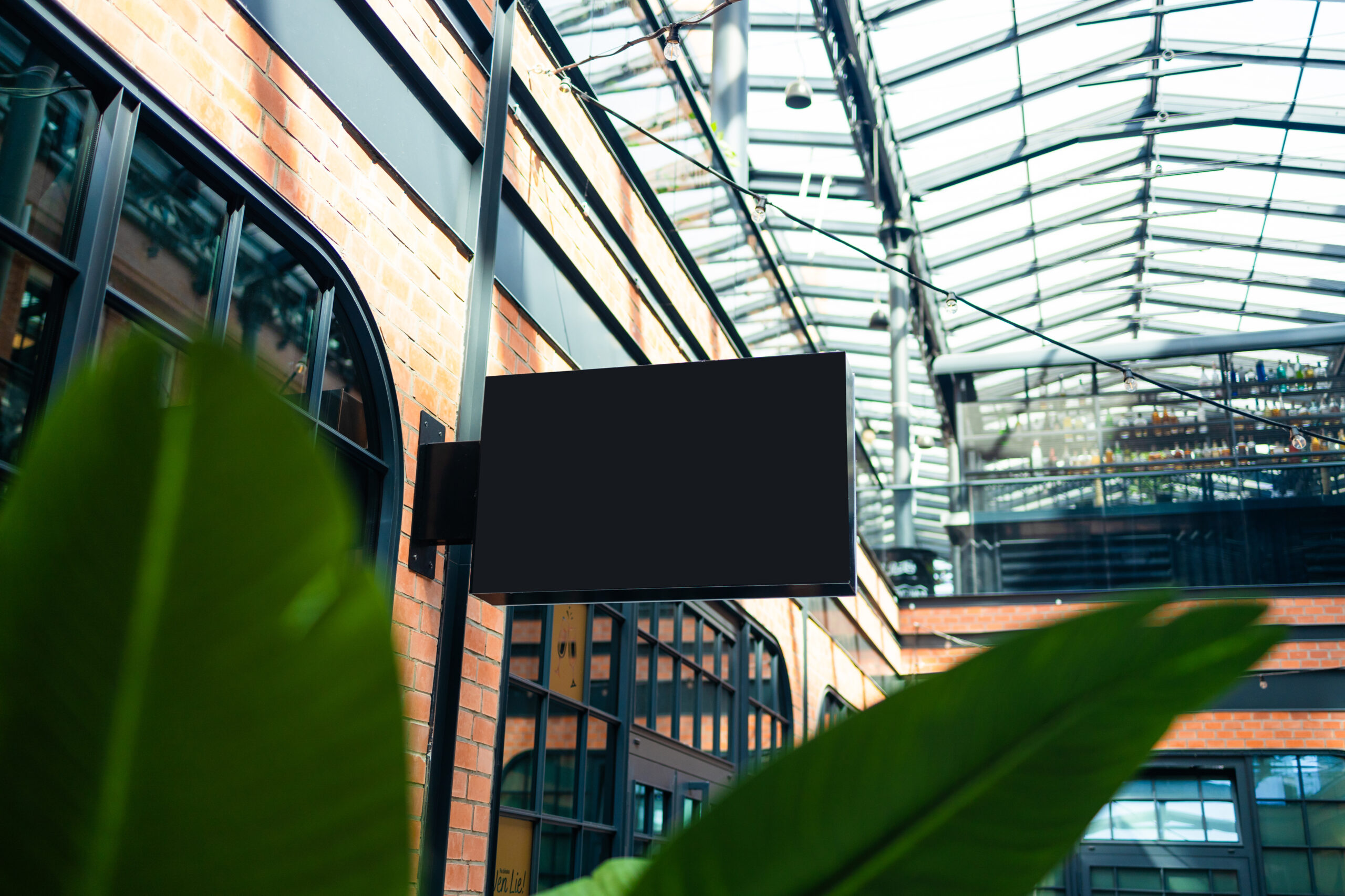 Blank projecting business sign mounted on a commercial building exterior.