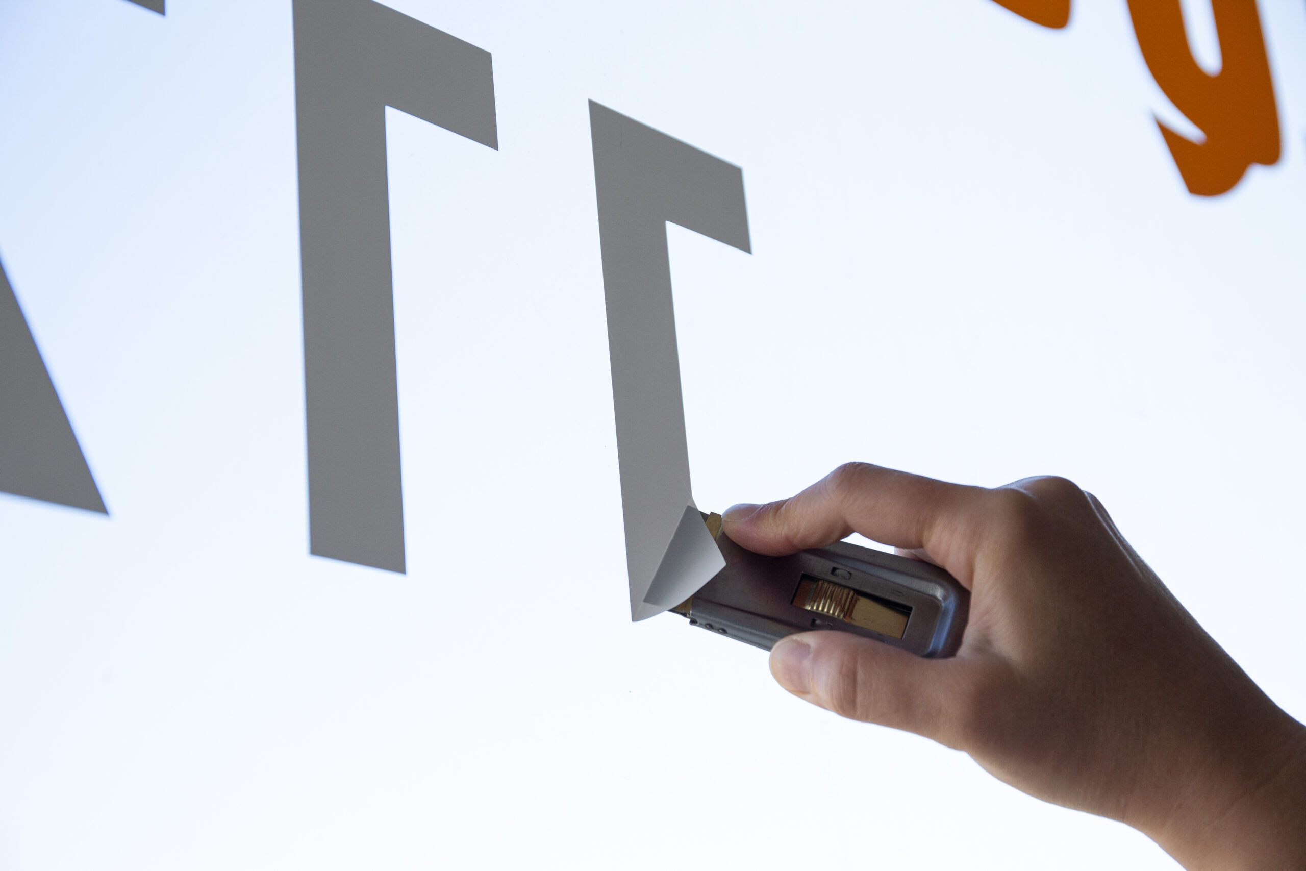 Woman hand removing a vinyl sticker