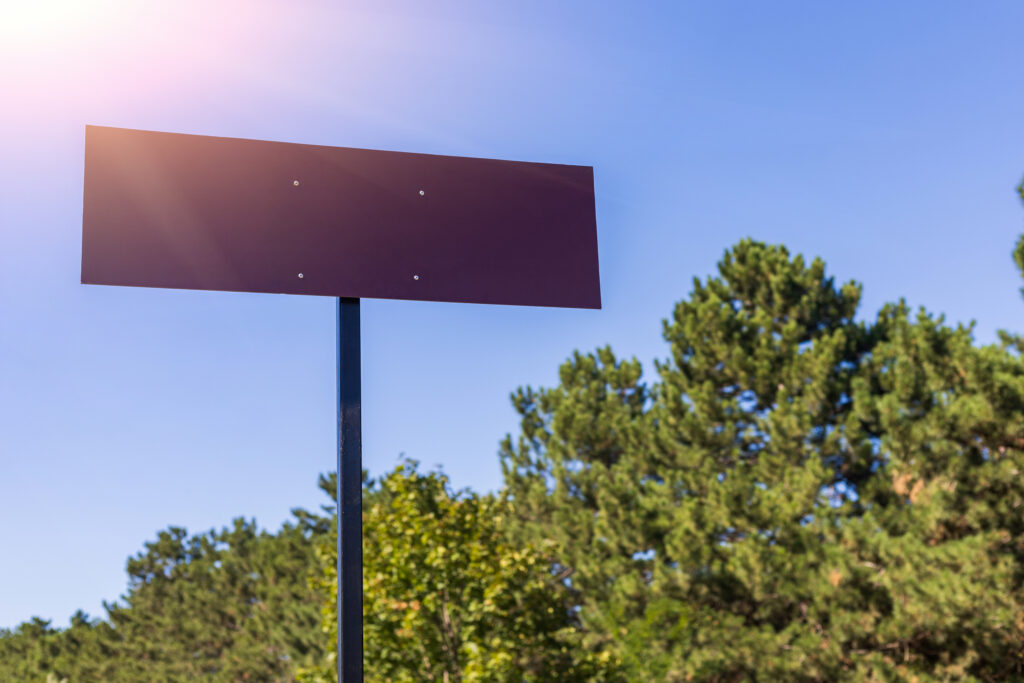 sign-against-a-blue-sky-surrounded-by-trees