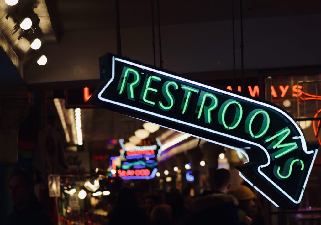 vibrant-neon-restroom-sign-illuminates-urban-area