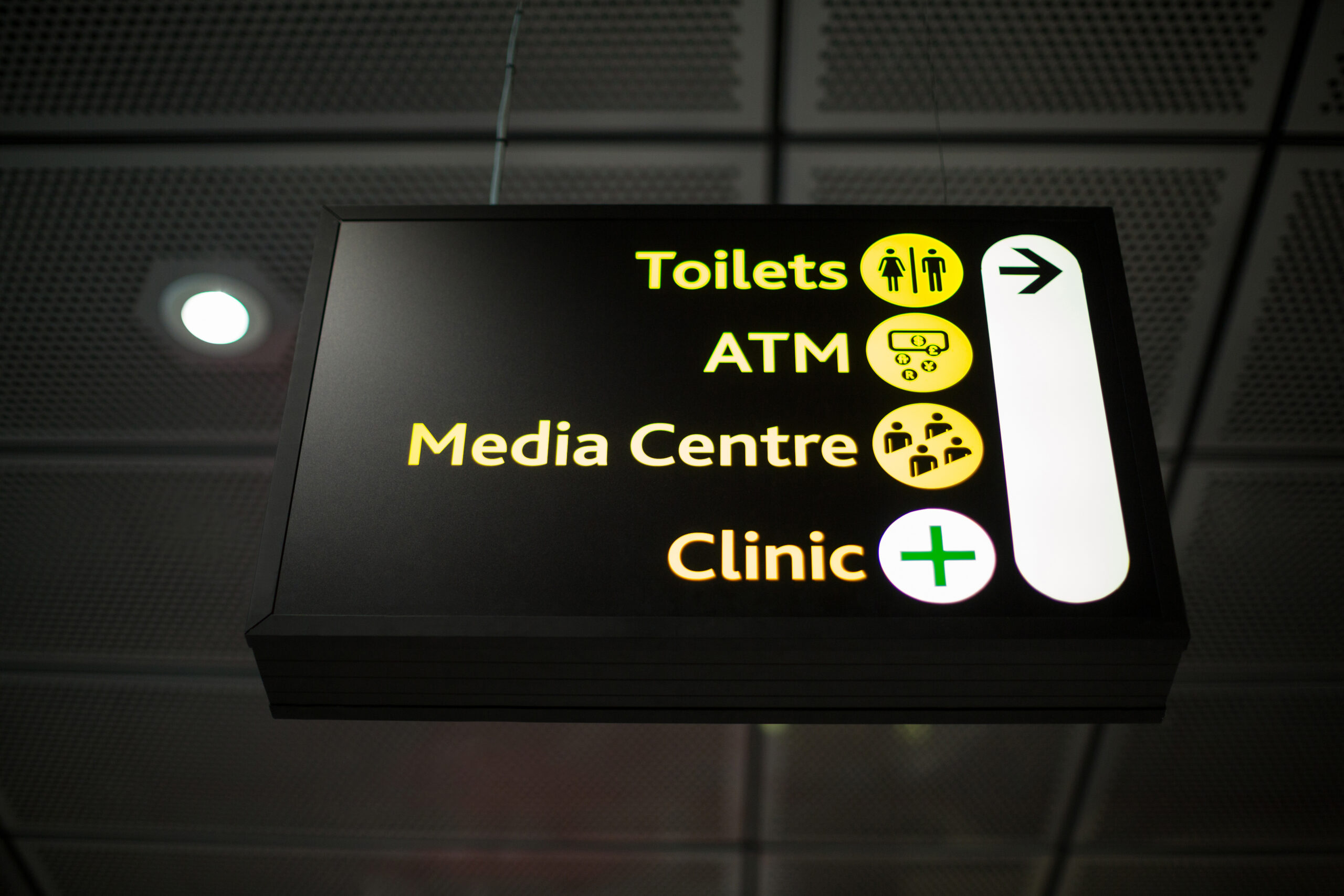 Illuminated outdoor information board displaying business signage at night with bright LED lighting for clear visibility.