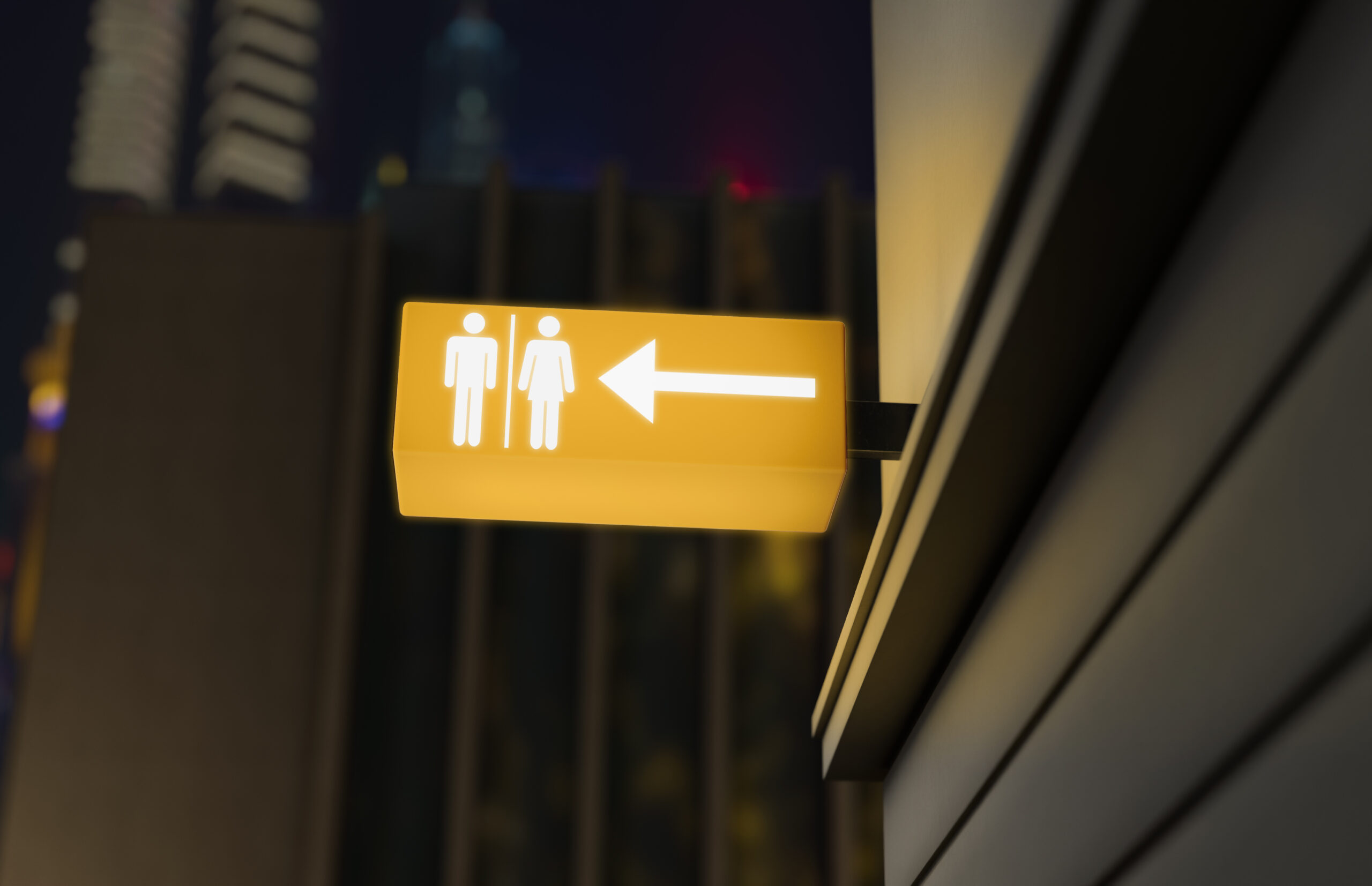 Yellow restroom symbols on wall