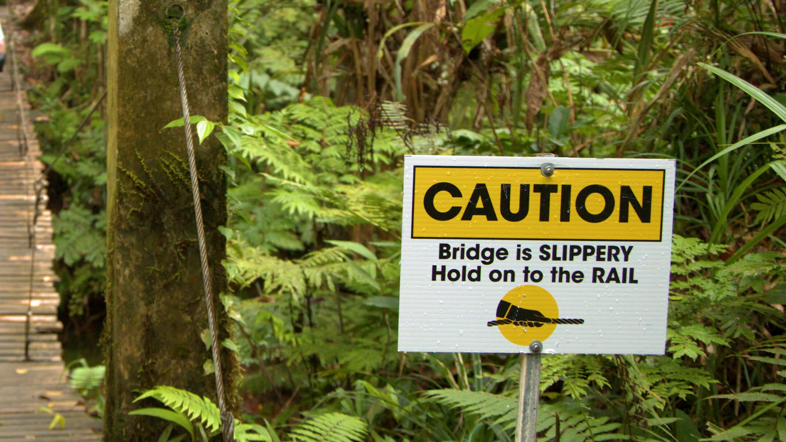Yellow caution sign on bridge